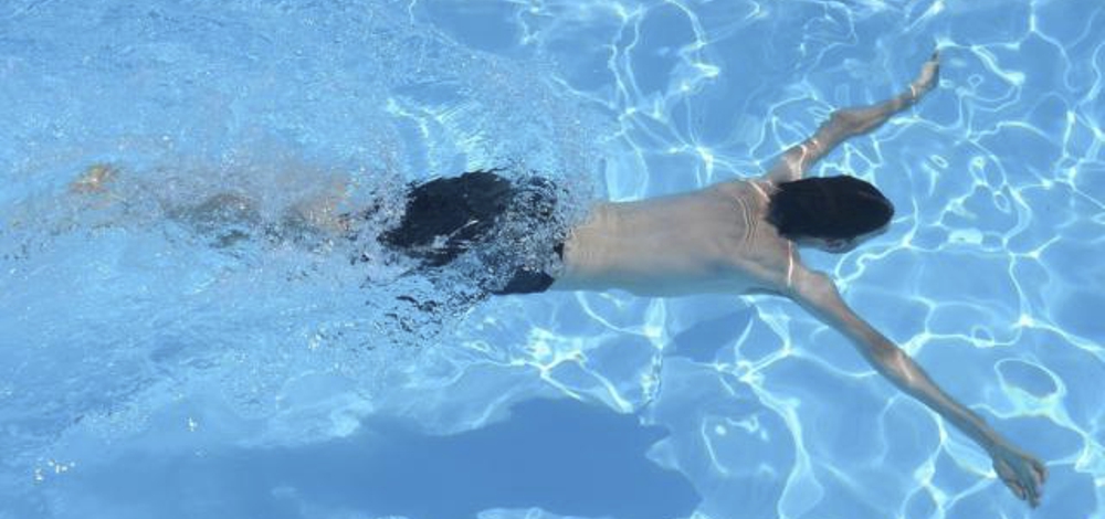Two funny girls playing in swimming pool. Vacation and travel concept